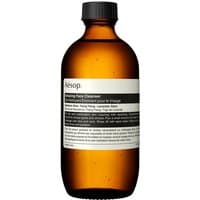 Amber bottle of Aesop Amazing Face Cleanser, 200 ml, with black cap and minimalist white label.
