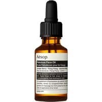 Amber glass bottle with black dropper, Aesop Fabulous Face Oil label in white, 25 ml size.