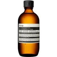 Amber bottle of Aesop In Two Minds Facial Toner, black cap, white label with black text, 200 ml.