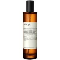 Amber bottle of Aesop Istros Floral Room Spray with black cap and minimalist white label.