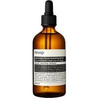 Amber glass bottle with black dropper, white label, Aesop Lightweight Facial Hydrating Serum, 100 ml.