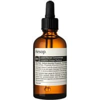 Amber glass bottle with black dropper cap, labeled "Aesop Lucent Facial Concentrate 60 ml" in black and white text.