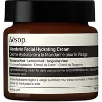 Brown glass jar of Aesop Mandarin Facial Hydrating Cream with black lid and bilingual label detailing ingredients.
