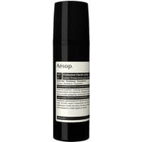 Black Aesop bottle with white label, Protective Facial Lotion SPF 25, 50 ml, sleek cylindrical design.