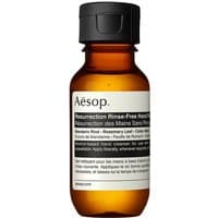 Amber bottle of Aesop Resurrection Rinse-Free Hand Wash, black cap, white label with black text, 50 ml size.