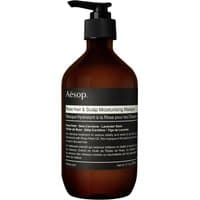 Brown pump bottle labeled "Aesop Rose Hair & Scalp Moisturising Masque" with black and white text, 500 ml size.