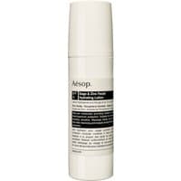 White cylindrical bottle of Aesop Sage & Zinc Facial Hydrating Lotion SPF15 with black label detailing.