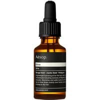 Amber glass bottle with black dropper cap, labeled "Aesop Shine" for nourishing weak, brittle hair, 25 ml size.