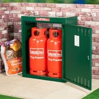 Green metal storage unit for 19kg gas bottles, vented sides, open door showing two red gas cylinders inside.