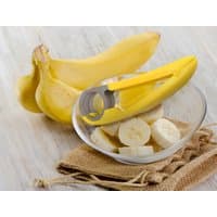 Yellow Avilo banana slicer with circular blades next to sliced bananas in a glass bowl.