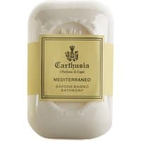 Cream-colored Carthusia Mediterraneo soap bar with embossed logo and yellow label.