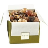 Green and white box of Christian Tortu Forets Pot Pourri, filled with dried botanicals and aromatic elements.