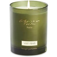 Green glass Christian Tortu Vert Frais citrus candle with white wax and elegant script label.