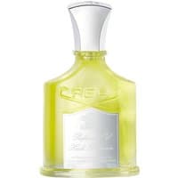 Clear bottle of Creed Love in White body oil, silver cap, embossed logo, white label with elegant script.