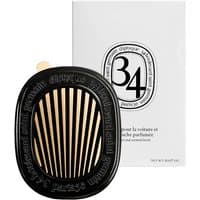 Diptyque 34 Car Diffuser, black oval with gold slats, branded text, white packaging with black logo.