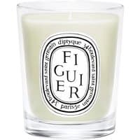 Diptyque Figuier candle in clear glass jar, white wax, black and white oval label with text.