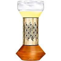 Diptyque citrus diffuser with ornate gold-patterned center, clear top, and amber base, containing yellow liquid.
