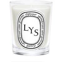 Clear glass jar with white wax, featuring "LYS" label and Diptyque branding in black text.