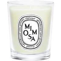 Clear glass jar with white wax, black "Mimosa" label, Diptyque floral candle, 70g.