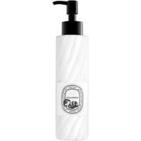 White cylindrical bottle of Diptyque Philosykos lotion with black pump and elegant label design.