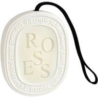 White Diptyque Roses scented oval with embossed text and black hanging cord.