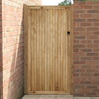 Wooden 3'x6' side entry gate with vertical slats, pressure treated for noise reduction, set between brick walls.