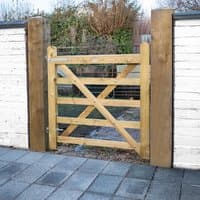 Wooden Forest Croft Prestige gate, 4'x4', with diagonal cross-bracing, framed by brick and wood posts.