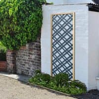 Grey wooden diamond lattice panel with natural frame, 5'11 x 2', leaning against a white wall, surrounded by greenery.