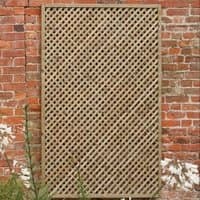 Wisley Diamond Lattice Trellis Panel, rectangular wood frame with crisscross pattern, against a red brick wall.