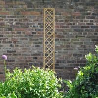 Wooden lattice trellis with diamond pattern, 6' x 1', light brown finish, against a brick wall.