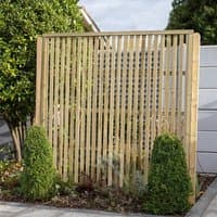 Forest Garden 6'x6' pressure-treated vertical slatted screen panel, natural wood finish, set in a garden.