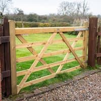 Wooden Croft Prestige gate, 7'x4', with diagonal cross-bracing and natural finish, set between dark wooden posts.