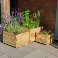 Wooden garden planters set of 3, square shape, natural finish, filled with various plants, placed on a patio.