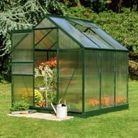 Green frame polycarbonate greenhouse with clear panels, pitched roof, and open door, set on grass.