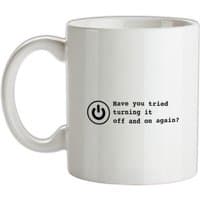 White ceramic mug with black text "Have you tried turning it off and on again?" and a power symbol.