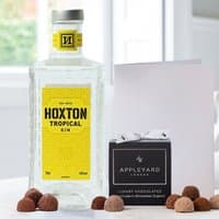 Hoxton Tropical Gin bottle with yellow label, 12 chocolate truffles, and a white occasion card.