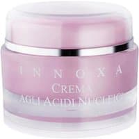Pink and white jar of Innoxa regenerating face cream with silver accents, labeled "Crema agli Acidi Nucleici 50 ml".