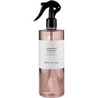 Pink bottle of Laboratorio Olfattivo Petali di Tiare floral room spray with black trigger nozzle.