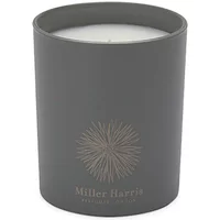Gray Miller Harris candle with gold logo, "Infusion de The" text, in a sleek cylindrical holder.