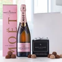 Moët & Chandon Rosé Champagne with pink box, 12 assorted chocolate truffles in black box, and a white occasion card.
