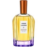 Amber-hued Molinard Ambre Lumiere perfume bottle with copper cap and purple base, 90 ml size.