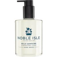 Clear bottle of Noble Isle Wild Samphire Hand Wash with black pump and blue floral logo.