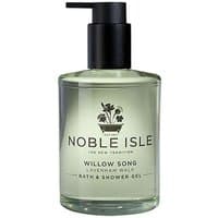 Clear bottle of Noble Isle Willow Song Bath & Shower Gel, black pump, floral logo, and green liquid, 250 ml.