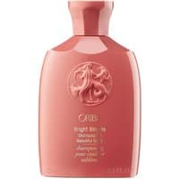 Pink Oribe Bright Blonde Shampoo bottle, 75 ml, with embossed logo and gold text for dry, dyed, and bleached hair.