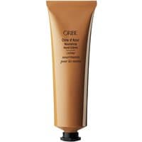 Gold tube of Oribe Cote d'Azur Nourishing Hand Cream, black cap, elegant branding text on front.