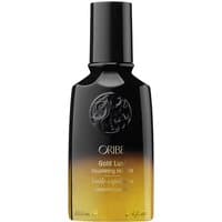 Black and gold Oribe Gold Lust Hair Oil bottle with embossed logo and 100 ml label.