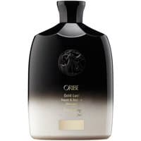 Black and gold gradient Oribe shampoo bottle with embossed logo and black cap, 250 ml size.