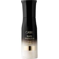 Black and white Oribe Mystify Restyling Spray bottle, 50 ml, with gold accents and sleek design.