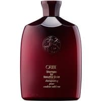 Burgundy Oribe shampoo bottle with embossed logo, gold text, and a sleek, rectangular shape for colored hair care.