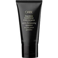 Black Oribe Signature Conditioner travel size tube with gold text and flip-top cap.